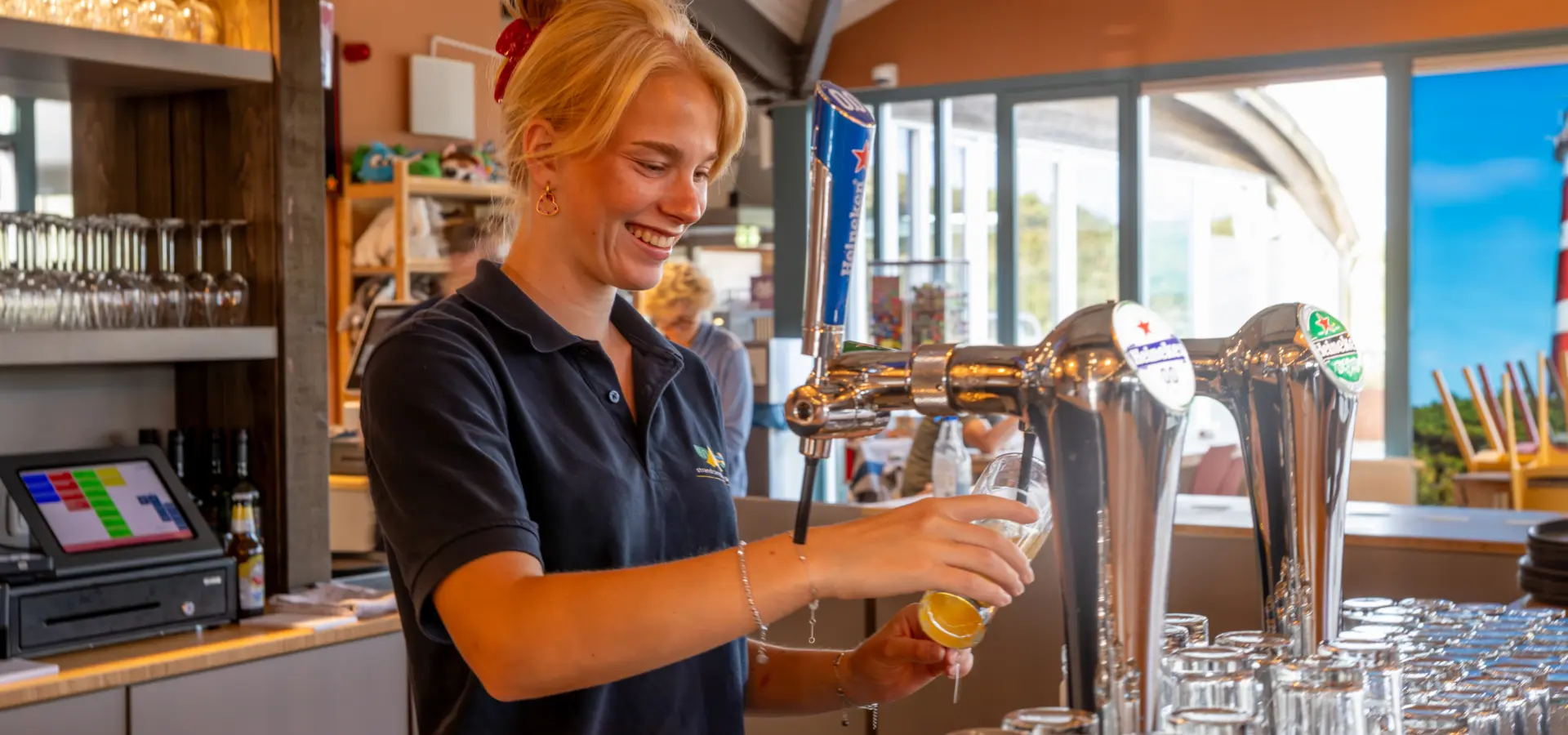 Vakantiemedewerker achter de bar Strandcamping Duinoord Ameland